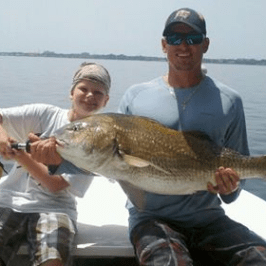 Boy and man holding fish