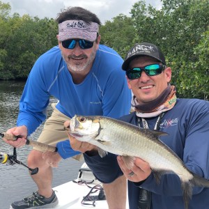 a man holding a fish in the water