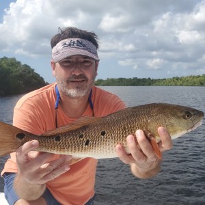 a man holding a fish