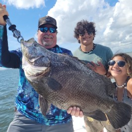 a man holding a fish in the water