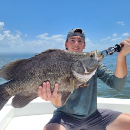 a person holding a fish in the water