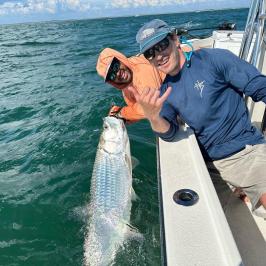 a man holding a fish in the water