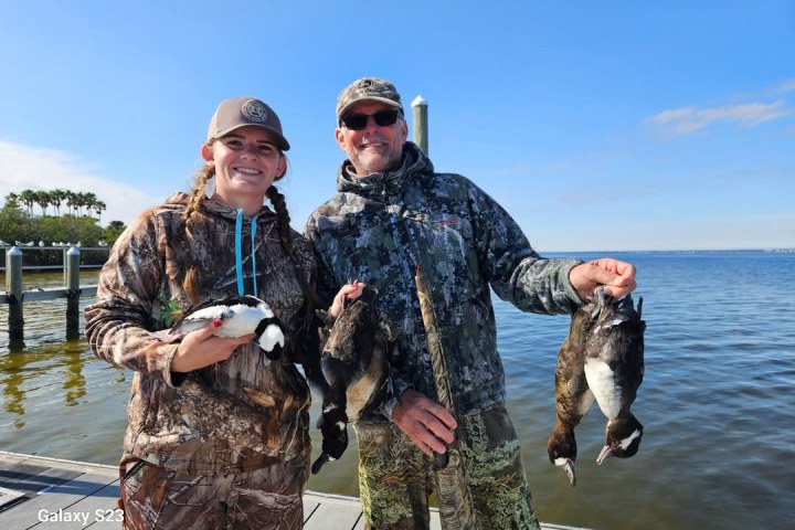a person holding a fish in the water